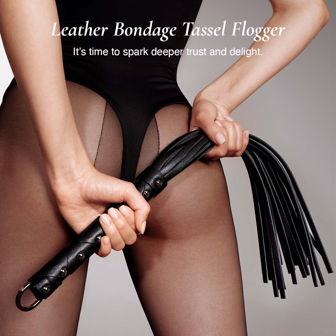 Person holding the osuga leather bondage tassel flogger to spark deeper and delight.